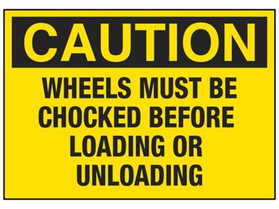 "Wheels Must Be Chocked Before Loading or Unloading" Sign