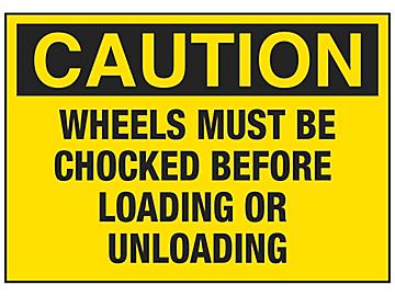 "Wheels Must Be Chocked Before Loading or Unloading" Sign